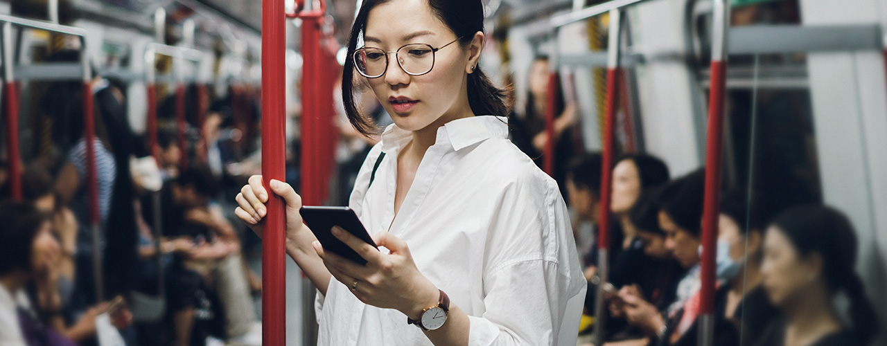 Woman looking at her phone on the train